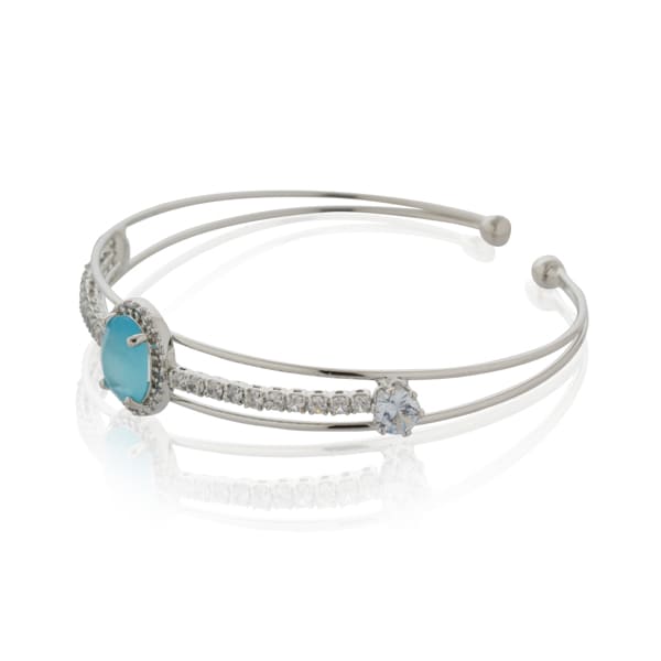 MAKE A SPLASH WITH THIS STUNNING AQUA-COLORED STONE-STUDDED ZIRCON BRACELET. THE VIBRANT AQUA STONES, PAIRED WITH SPARKLING ZIRCON ACCENTS.