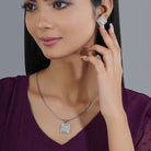 925 silver pendant set with zircon-studded earrings, adding sophisticated sparkle.
