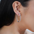 925 silver hoop earrings with sparkling zircon studs for an elegant, sophisticated look.
