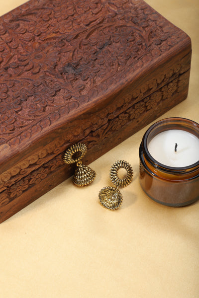 "Elegant oxidized jhumkas with golden detailing, merging traditional charm with a modern twist.
