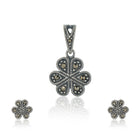 "925 silver pendant and earrings set with floral design, exuding elegance and sophistication."
