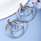 "Elegant oxidized silver hoop earrings with a unique ring design, blending modern and classic charm."
