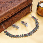 Elegant oxidized necklace set with green and pink stones, paired with matching jhumka earrings.
