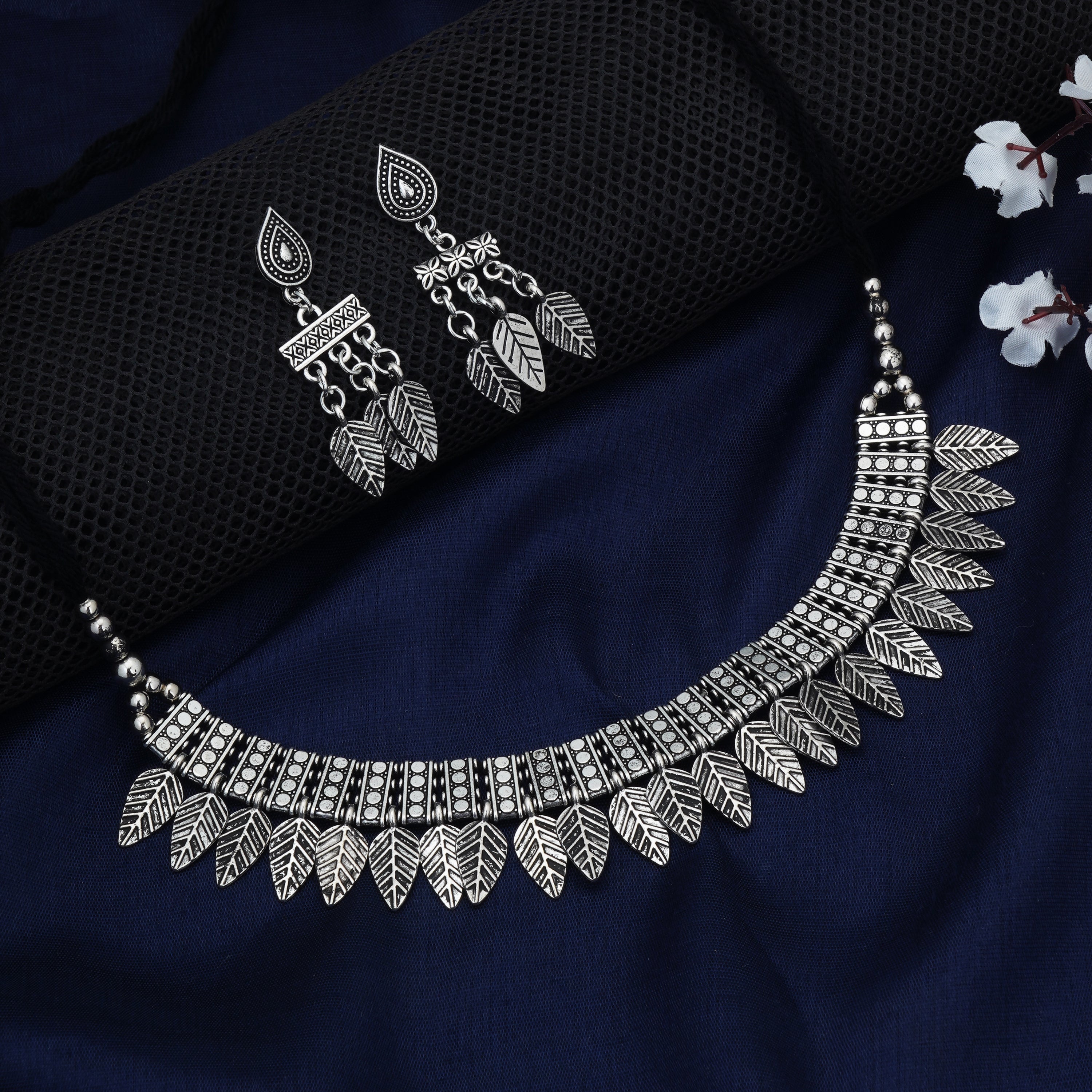 Stylish oxidized short necklace set with intricate leaf designs, perfect for festive elegance.
