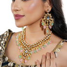 Stunning Kundan choker necklace with exquisite craftsmanship and embedded pearls for bridal look.
