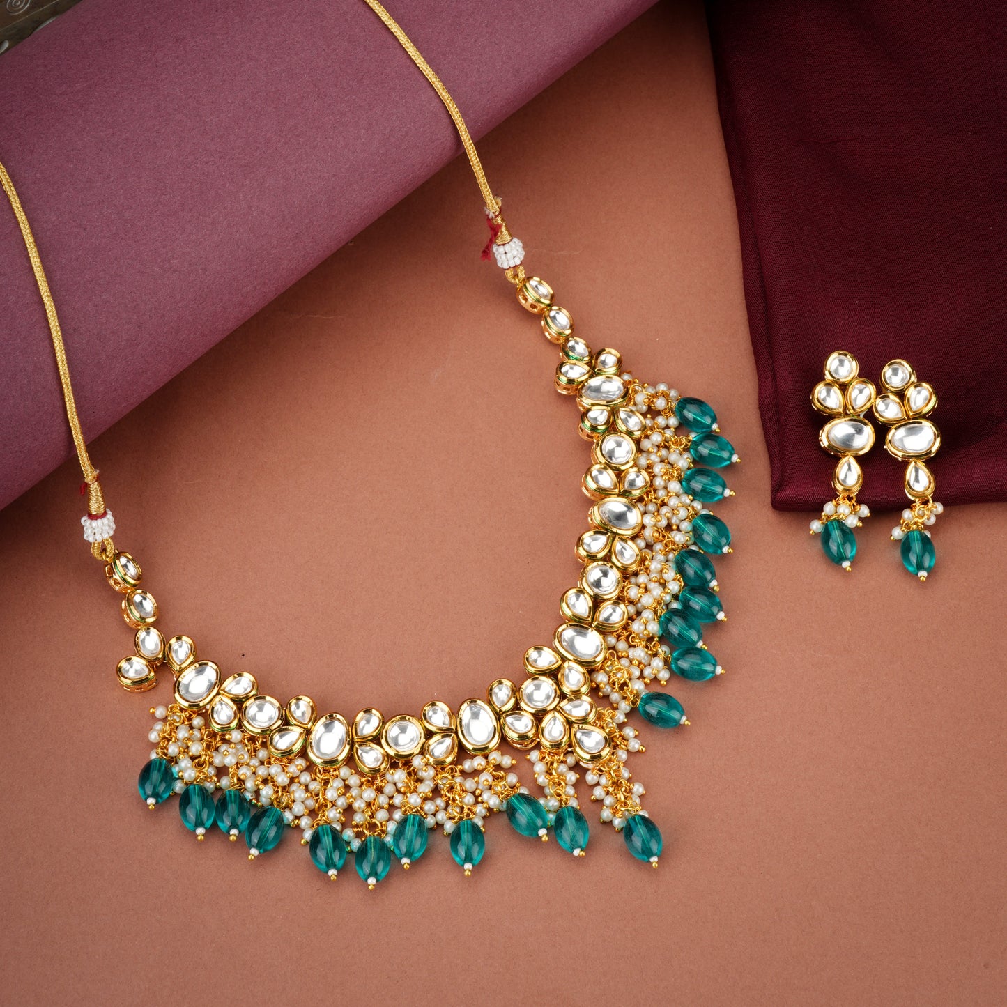 FESTIVE KUNDAN NECKLACE SET FEATURING STRIKING TEAL BIG PEARLS AND DELICATE WHITE SMALL PEARLS.