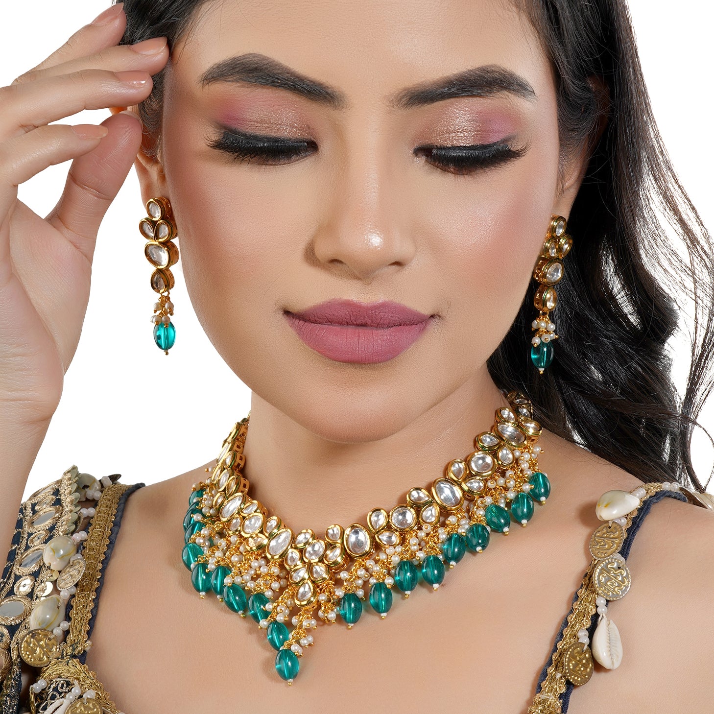 Festive Kundan necklace set with teal and white pearls, offering a vibrant and elegant touch.
