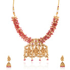  Radha Krishna temple necklace set with red pearls, showcasing intricate gold-tone craftsmanship.
