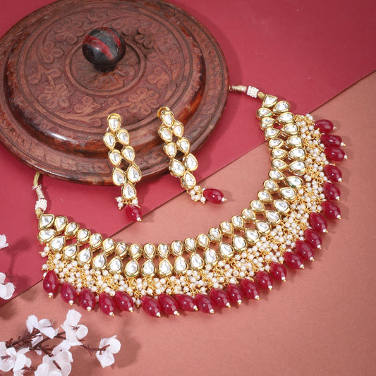 KUNDAN NECKLACE SET FEATURES TWO LAYERS OF EXQUISITE KUNDAN WORK, EMBELLISHED WITH RED PEARLS WITH MATCHING PAIR OF EARRINGS,