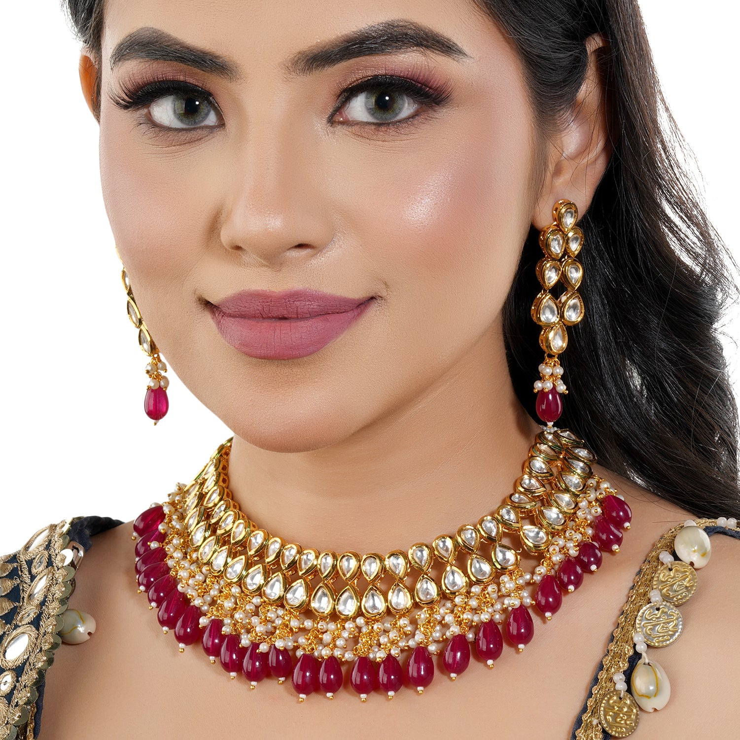 Kundan necklace set with red pearls, featuring two layers of intricate Kundan work and matching earrings.
