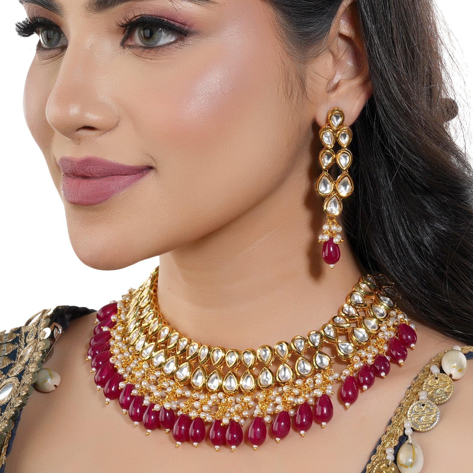 Kundan necklace set with red pearls, featuring two layers of intricate Kundan work and matching earrings.
