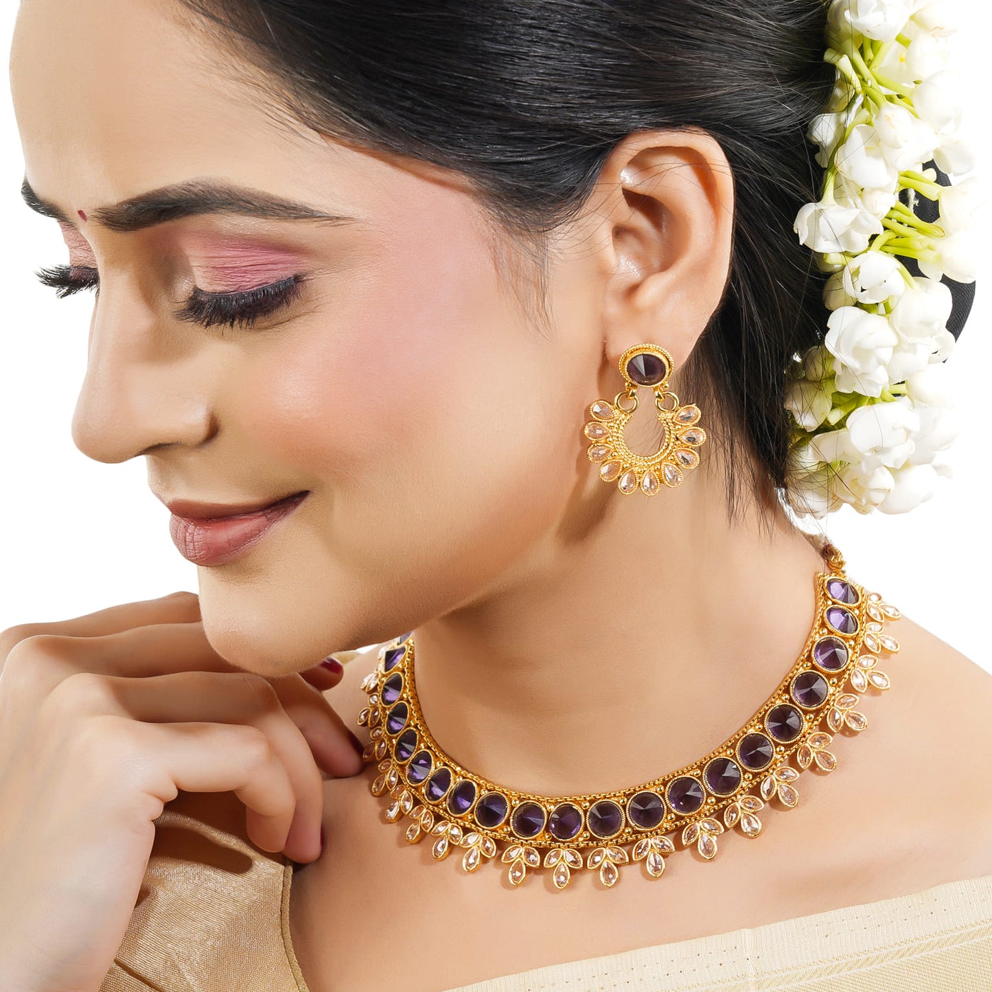 A PURPLE-COLORED KUNDAN-STUDDED NECKLACE SET FEATURES RICH PURPLE STONES PAIRED WITH INTRICATE KUNDAN WORK.