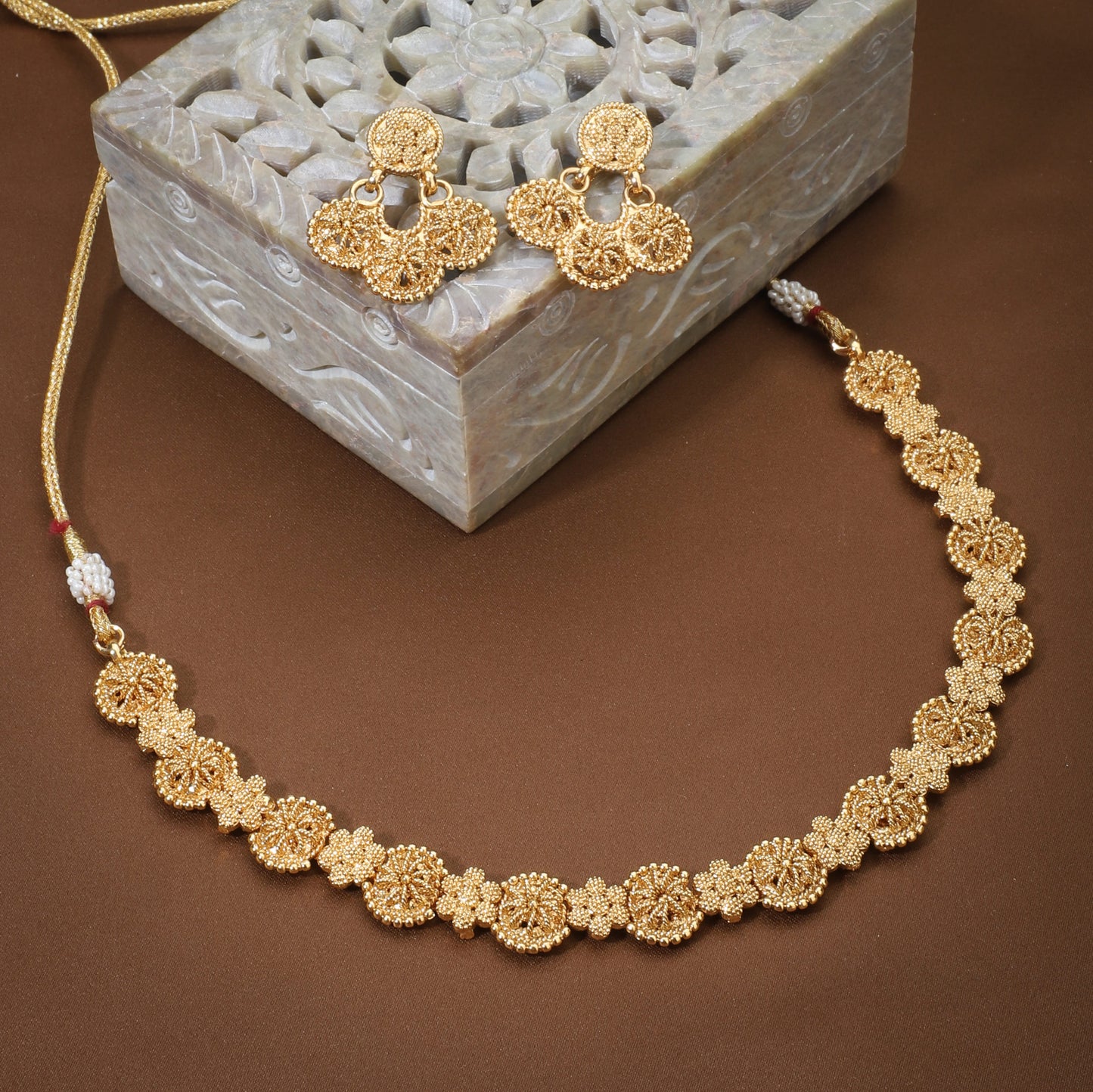 A GOLDTONE NECKLACE SET FEATURES A NECKLACE AND MATCHING EARRINGS WITH A GOLDEN FINISH,