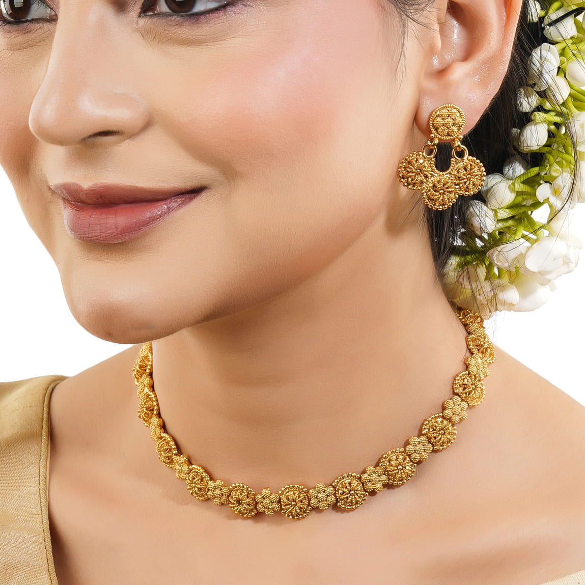 A GOLDTONE NECKLACE SET FEATURES A NECKLACE AND MATCHING EARRINGS WITH A GOLDEN FINISH,