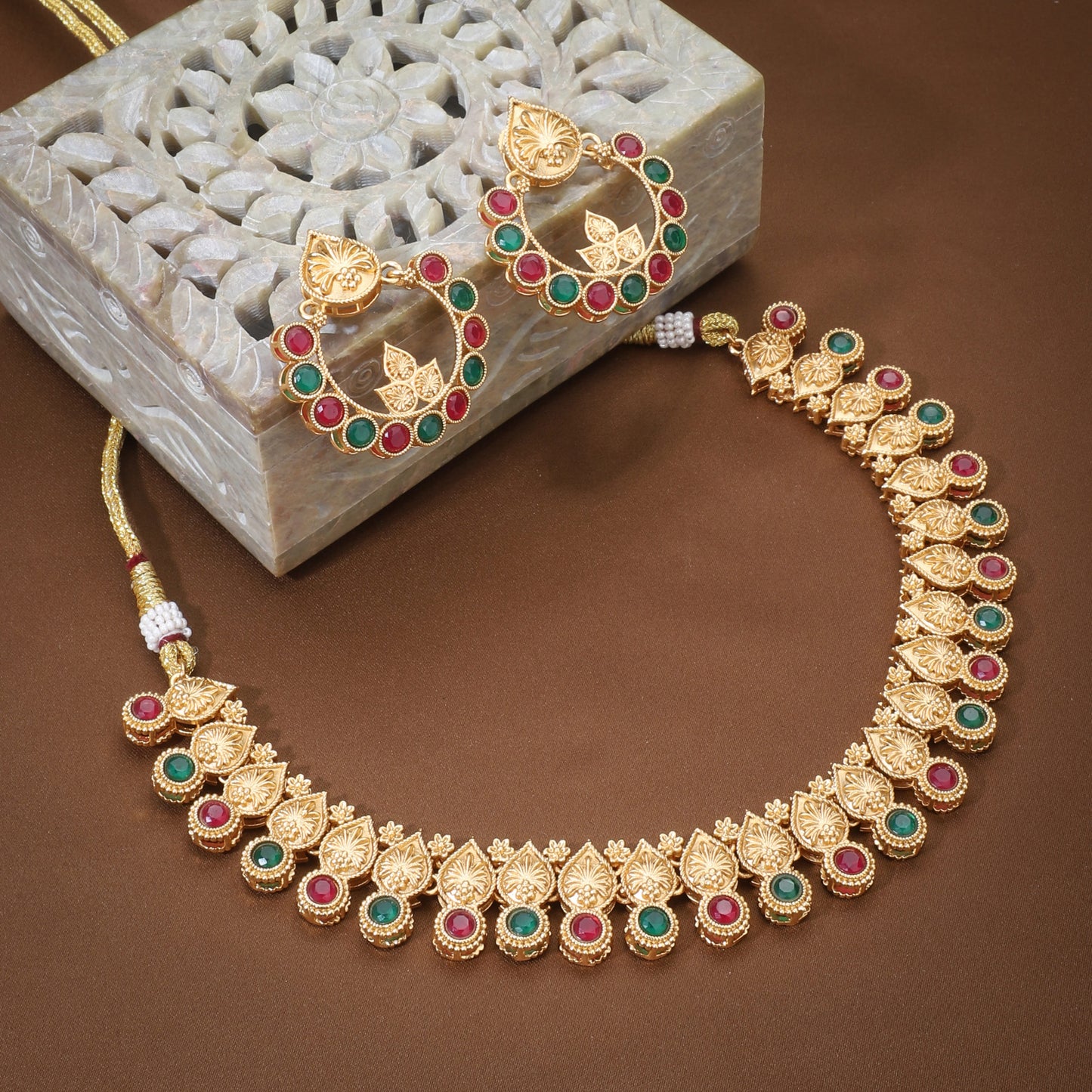 A GOLDTONE NECKLACE SET INCLUDES A NECKLACE AND MATCHING EARRINGS WITH A GOLD-COLORED FINISH,