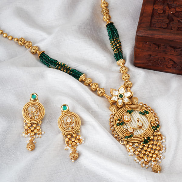 STUNNING GOLD-TONE LONG NECKLACE SET WITH ZIRCON STONES AND GREEN SMALL BEADS, COMBINING ELEGANCE WITH A POP OF COLOR.