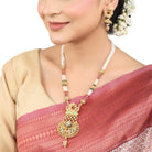 Elegant gold-tone long necklace set with white pearls, offering a classic and refined style."
