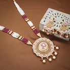 Elegant gold-tone long necklace set with Meekari design and small pearls, perfect for festive occasions.
