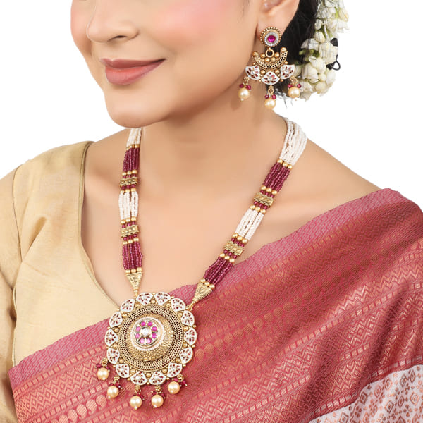 GOLDTONE LONG NECKLACE SET WITH MEEKARI DESIGN  ADORNED WITH SMALL PEARLS.