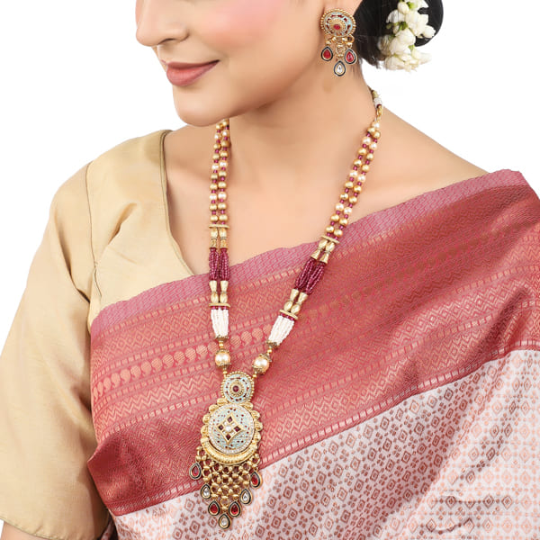 BEAUTIFULLY CRAFTED LONG GOLD-TONE NECKLACE SET FEATURING INTRICATE MEENAKARI DESIGN.