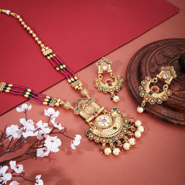 Stunning long gold-tone necklace set studded with multicolored stones, adding bold vibrance."
