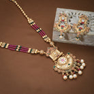 Stunning long gold-tone necklace set studded with multicolored stones, adding bold vibrance."
