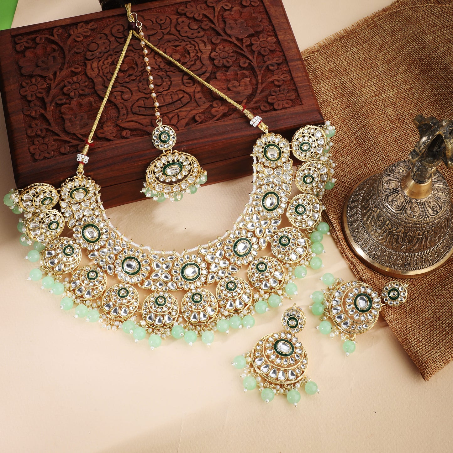 CA02CO04874GREEN-COLORED PEARLS-STUDDED BRIDAL SET INCLUDES A KUNDAN NECKLACE, MAANG TIKA, AND MATCHING EARRINGS.  THIS SET ADDS A REGAL AND ELEGANT TOUCH TO BRIDAL ATTIRE.