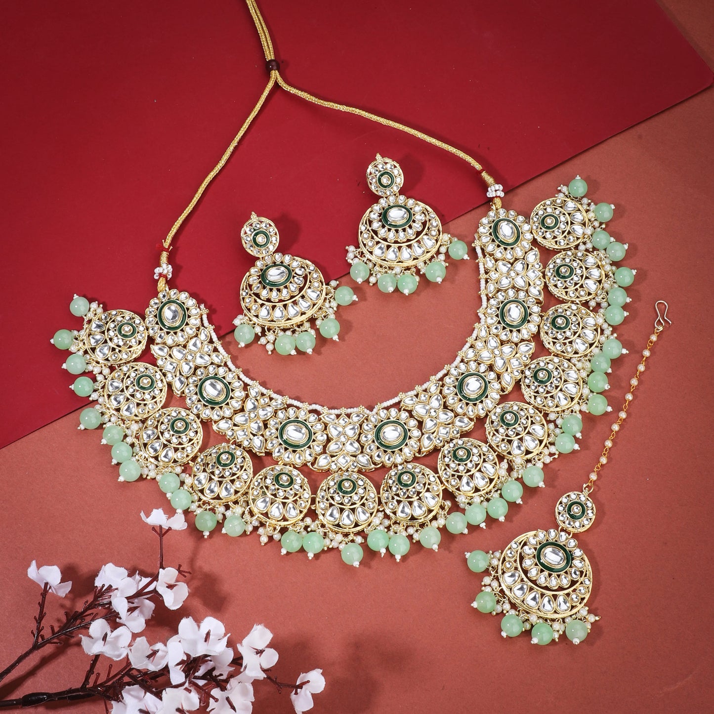 CA02CO04874GREEN-COLORED PEARLS-STUDDED BRIDAL SET INCLUDES A KUNDAN NECKLACE, MAANG TIKA, AND MATCHING EARRINGS.  THIS SET ADDS A REGAL AND ELEGANT TOUCH TO BRIDAL ATTIRE.