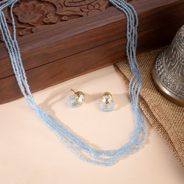 Delicate gold-tone necklace with small blue pearls, offering a subtle and elegant festive charm.
