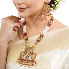 "Elegant gold-tone long necklace set with white pearls, adding a refined and classic festive touch."
