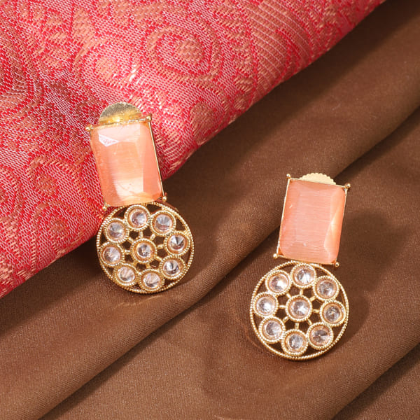 SALMON-COLORED STONES-STUDDED KUNDAN STUDS FEATURE  INTRICATE KUNDAN WORK.