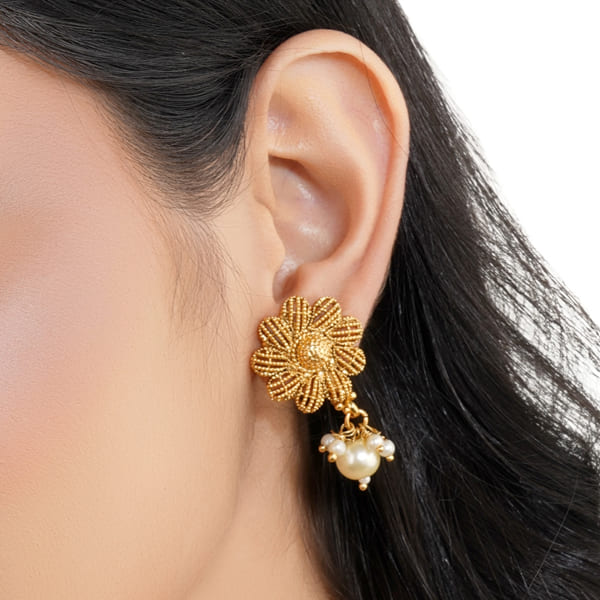 FLORAL DESIGN GOLDTONE EARRINGS FEATURE A GOLDEN FINISH WITH INTRICATE FLORAL PATTERNS.