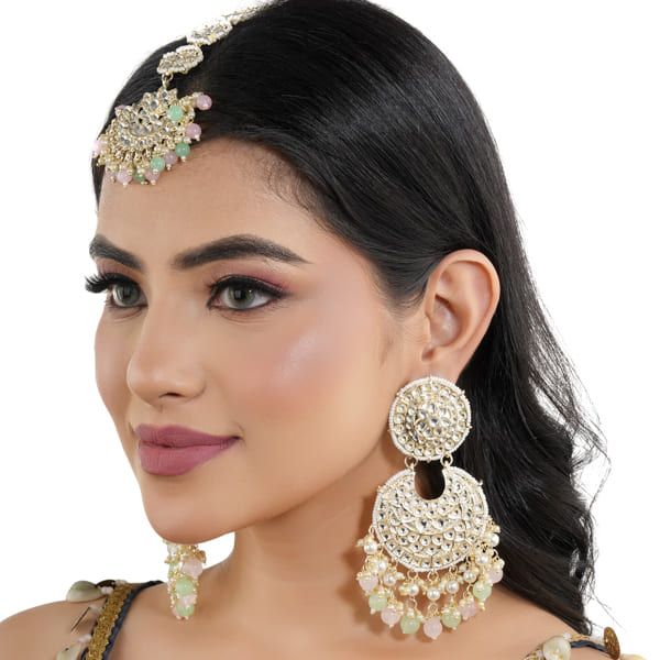 KUNDAN AND PEARL-STUDDED EARRINGS WITH MATCHING MAANG TIKKA, OFFERING A CLASSIC AND ELEGANT SET."