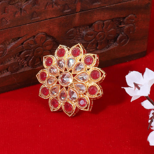 RED-COLORED KUNDAN-STUDDED FINGER RING FEATURES A STRIKING RED STONE SURROUNDED BY INTRICATE KUNDAN WORK.