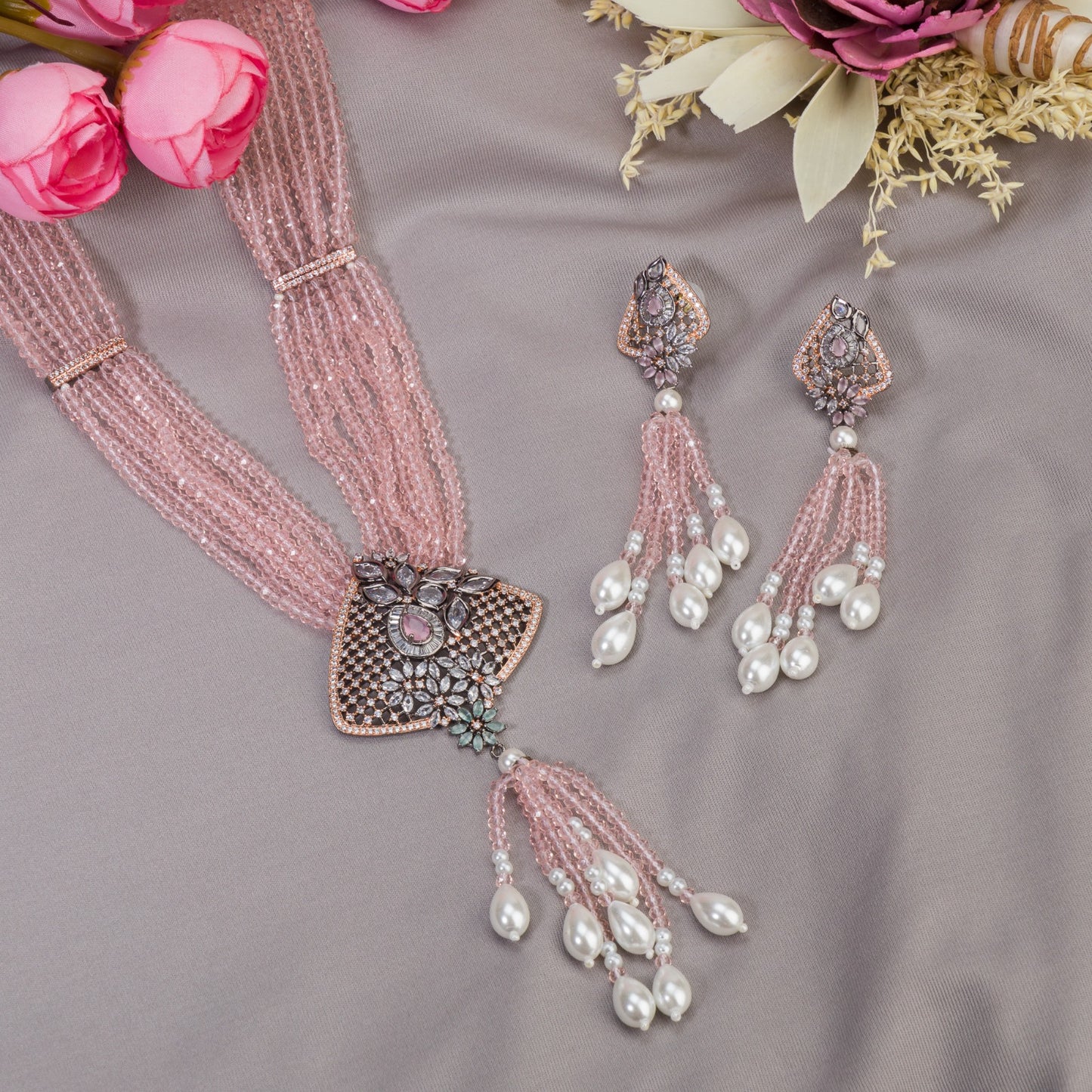 A PINK PEARL AND ZIRCON LONG NECKLACE OFFERS A DELICATE, RADIANT TOUCH.