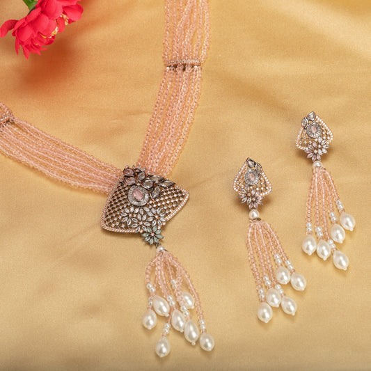 A PINK PEARL AND ZIRCON LONG NECKLACE OFFERS A DELICATE, RADIANT TOUCH.