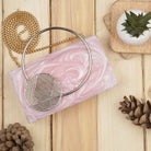 Elegant pink resin clutch with exquisite handle, perfect for elevating your party ensemble.
