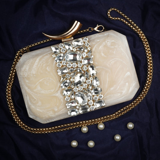 THIS CLUTCH FEATURING HEAVY STONE EMBELLISHMENTS, SOFT ELASTIC LINING, AND AN EXTRA POCKET FOR PRACTICAL STORAGE.